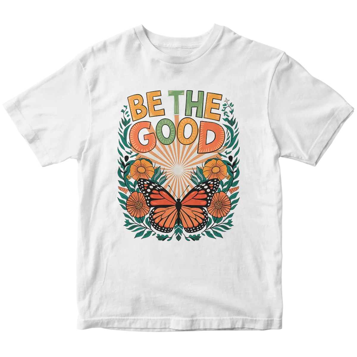 A white t-shirt with a custom DTF print featuring a monarch butterfly surrounded by a wreath of flowers and leaves. The design includes the inspirational text 'BE THE GOOD,' showcasing vibrant, high-quality DTF printing for custom apparel in Miami.